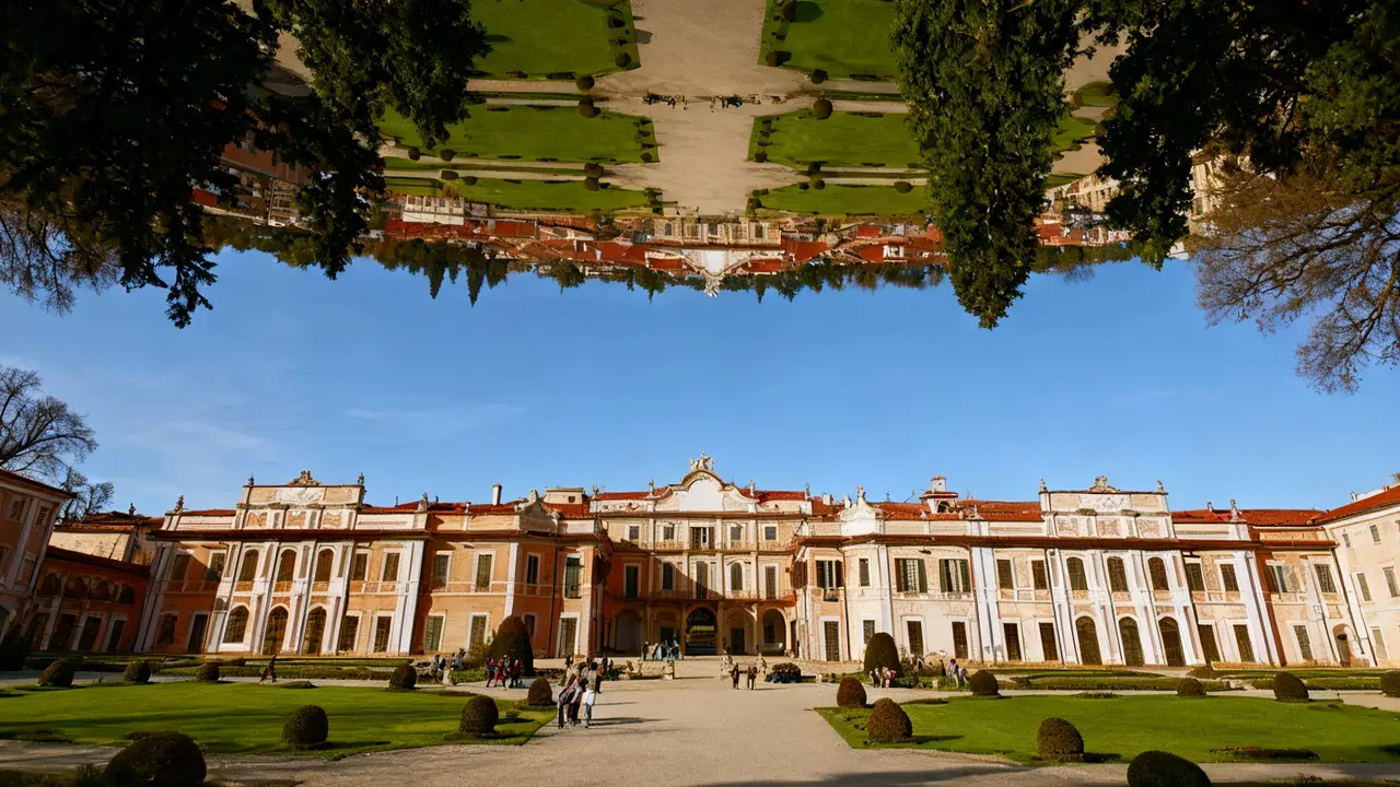 Facciata di una villa storica con giardino curato e visitatori sul vialetto